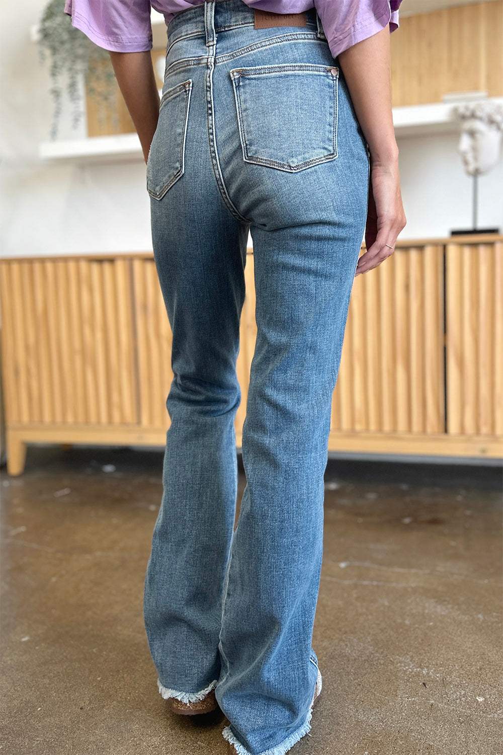 Trendy raw hem bootcut jeans by Judy Blue, perfect for casual or dressed-up outfits.