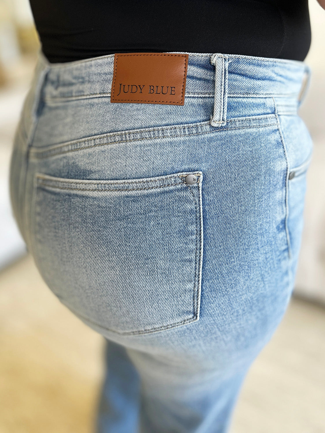 A close-up of the back of Judy Blue High Waist Wide Leg Jeans, highlighting the pockets and brand label.