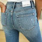 Highlight of the distressed look on the Judy Blue Mid Rise Destroyed Hem Distressed Jeans.