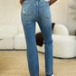 Full-length view of Judy Blue Mid Rise Destroyed Hem Distressed Jeans with destroyed hem.