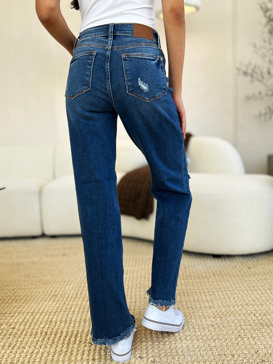 Back view of Judy Blue Mid Rise Distressed Raw Hem Jeans showcasing pocket design and raw hem.