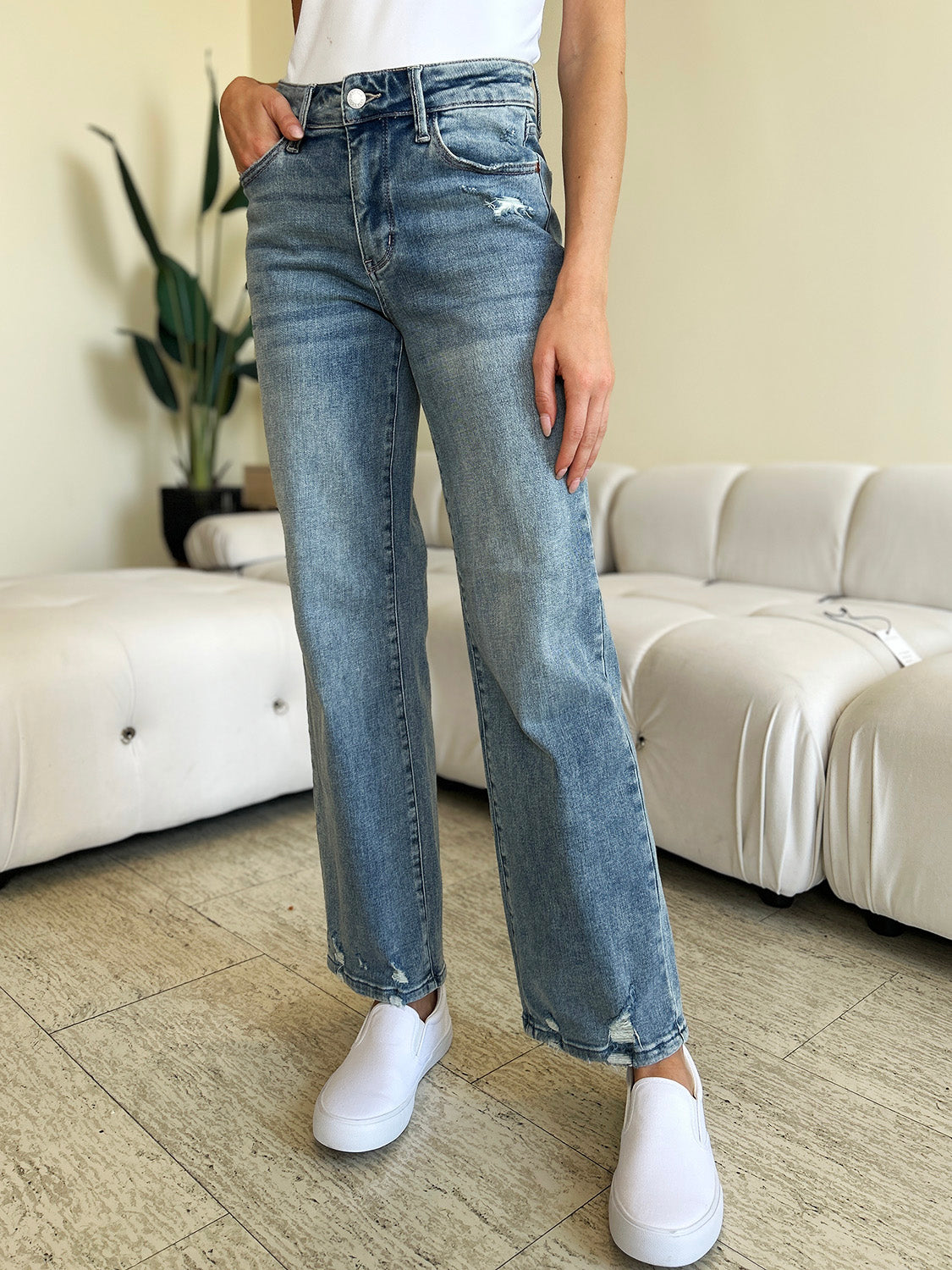 Judy Blue Mid Rise Distressed Straight Jeans paired with a white top and casual shoes.