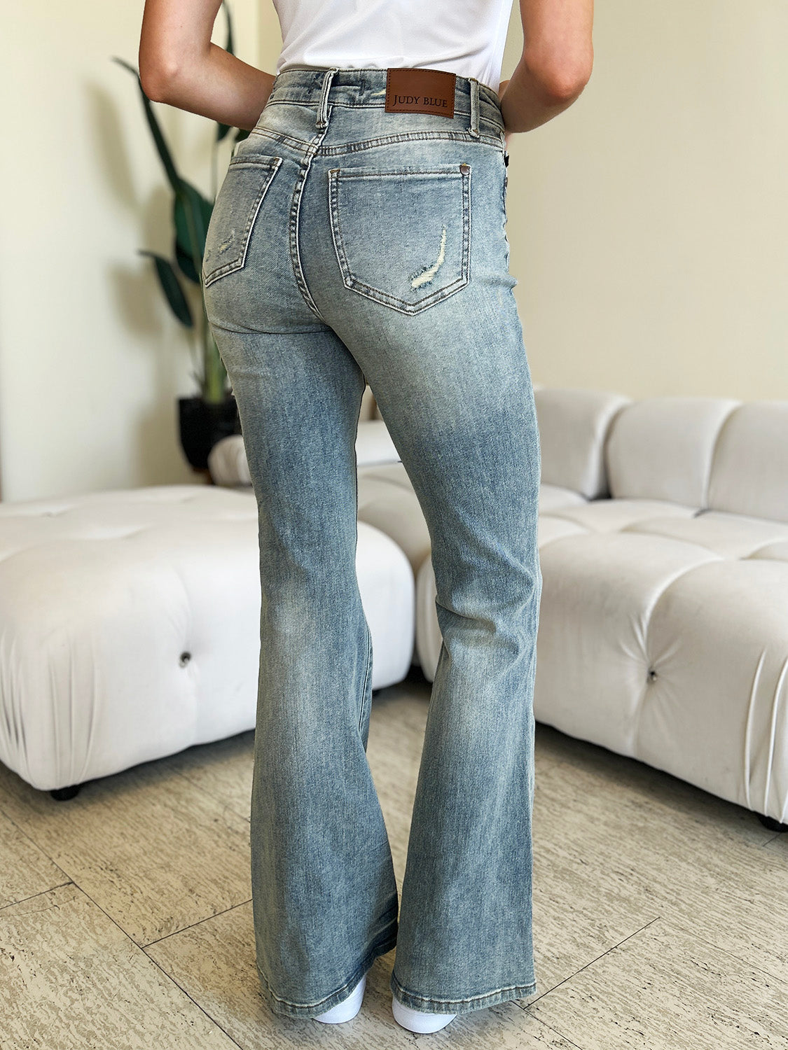 Judy Blue mid-rise flare jeans with slight distressing on pockets.