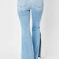 Back view of Judy Blue mid-rise raw hem slit leg flare jeans in light wash.