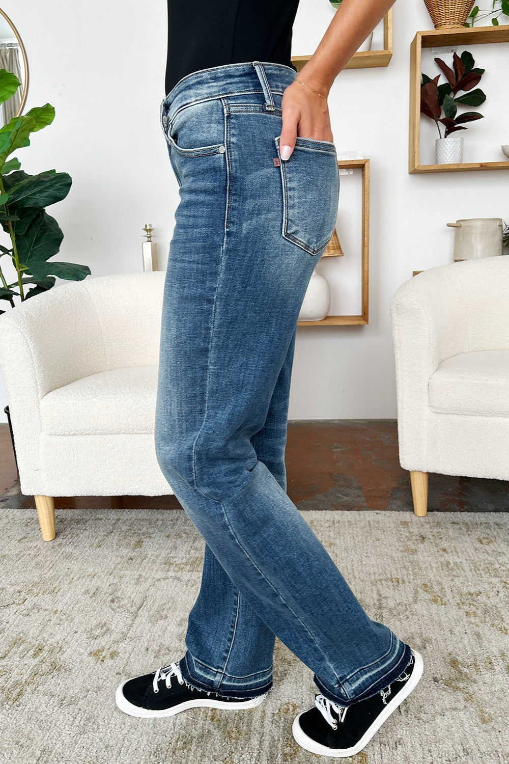 Side view of Judy Blue mid rise release hem jeans in medium wash.
