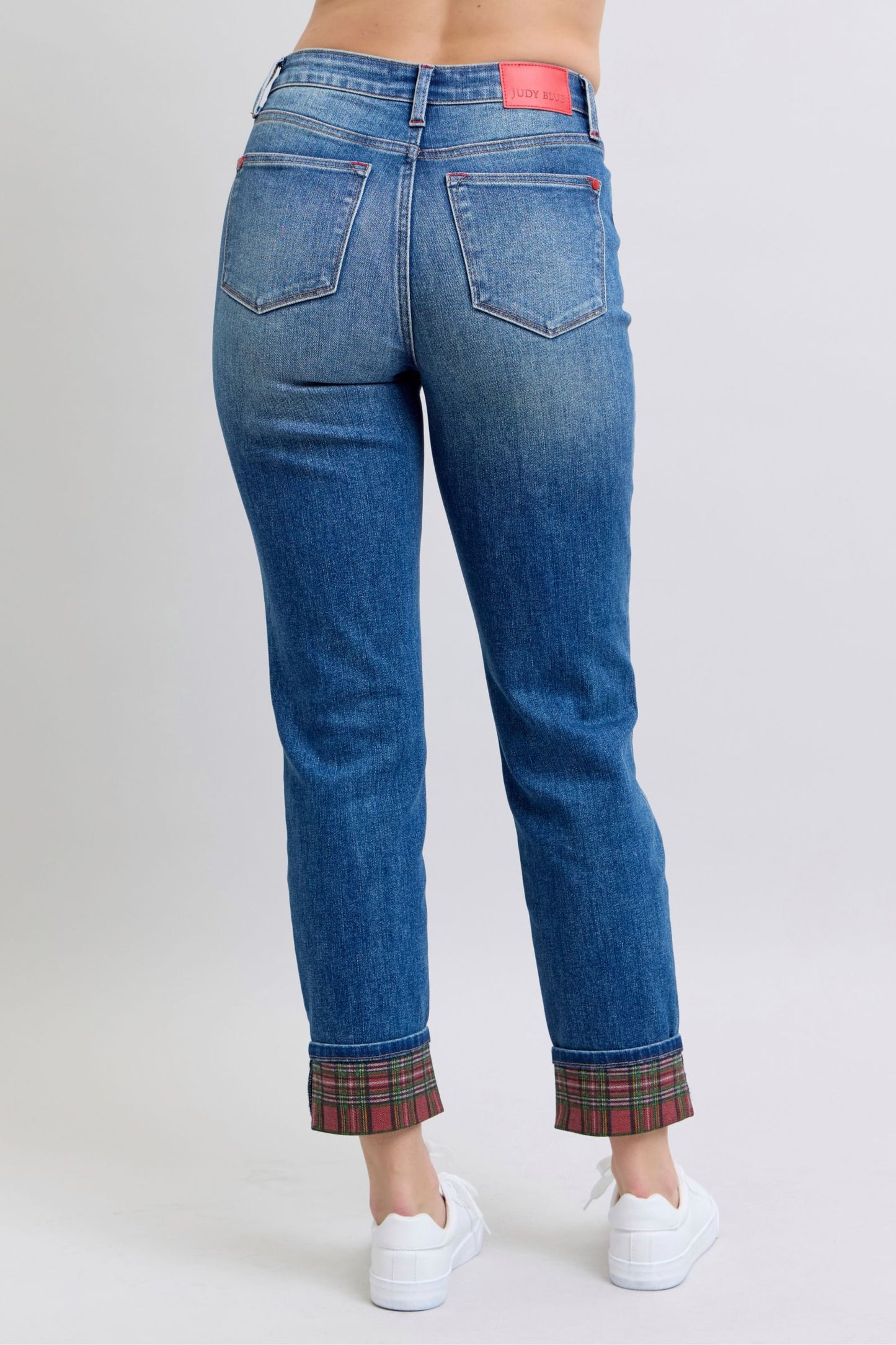 Rear view of Judy Blue straight leg jeans with plaid accents.
