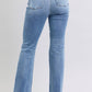 Back view of Judy Blue Raw Hem High Rise Bootcut Jeans with functional pocket details and high-rise design.
