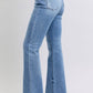 Closeup of waistband on Judy Blue Raw Hem High Rise Bootcut Jeans featuring button and stitch detailing.
