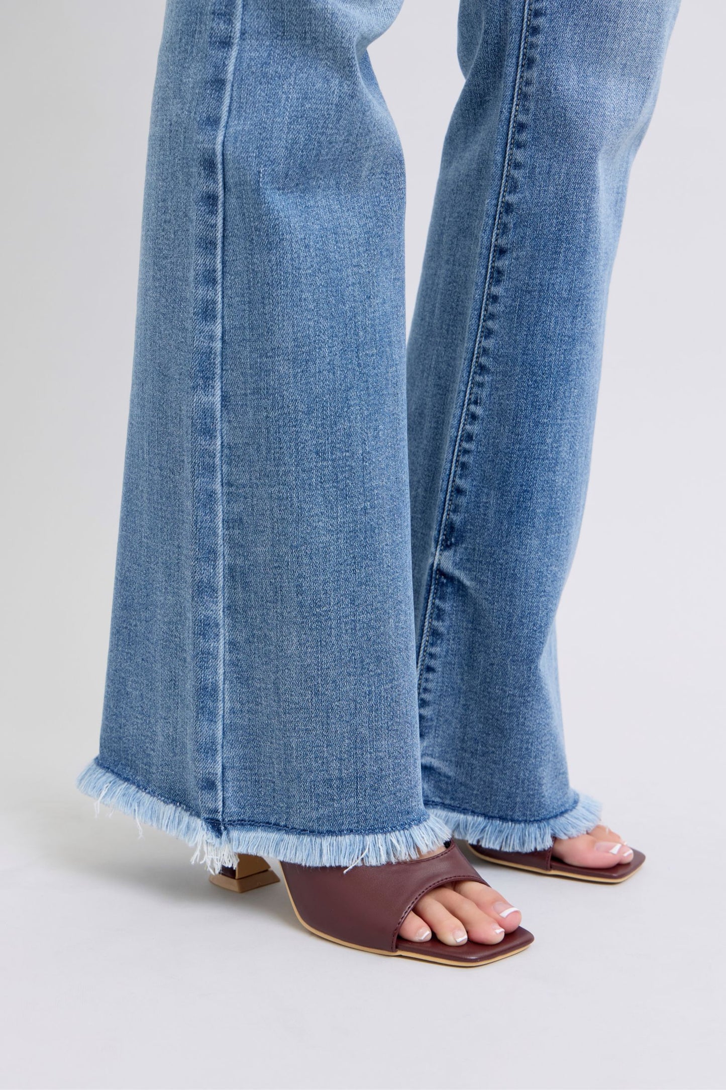 Raw hem closeup of Judy Blue Raw Hem High Rise Bootcut Jeans emphasizing edgy, modern design.
