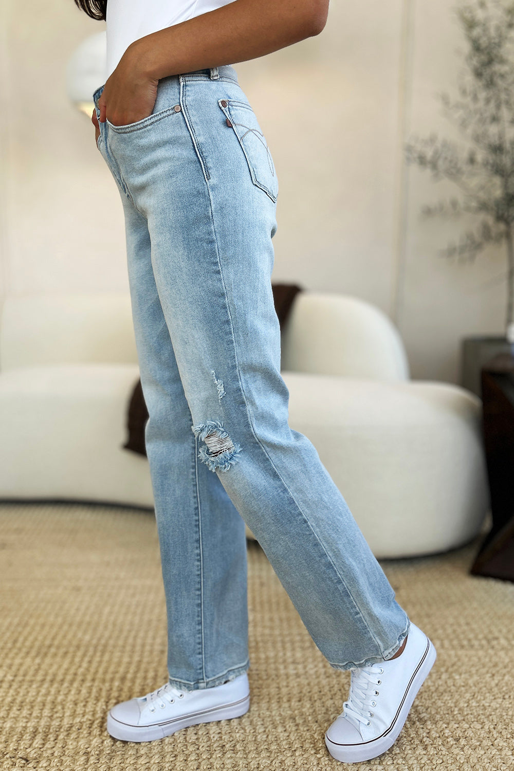 Full-length view of Judy Blue distressed straight jeans.