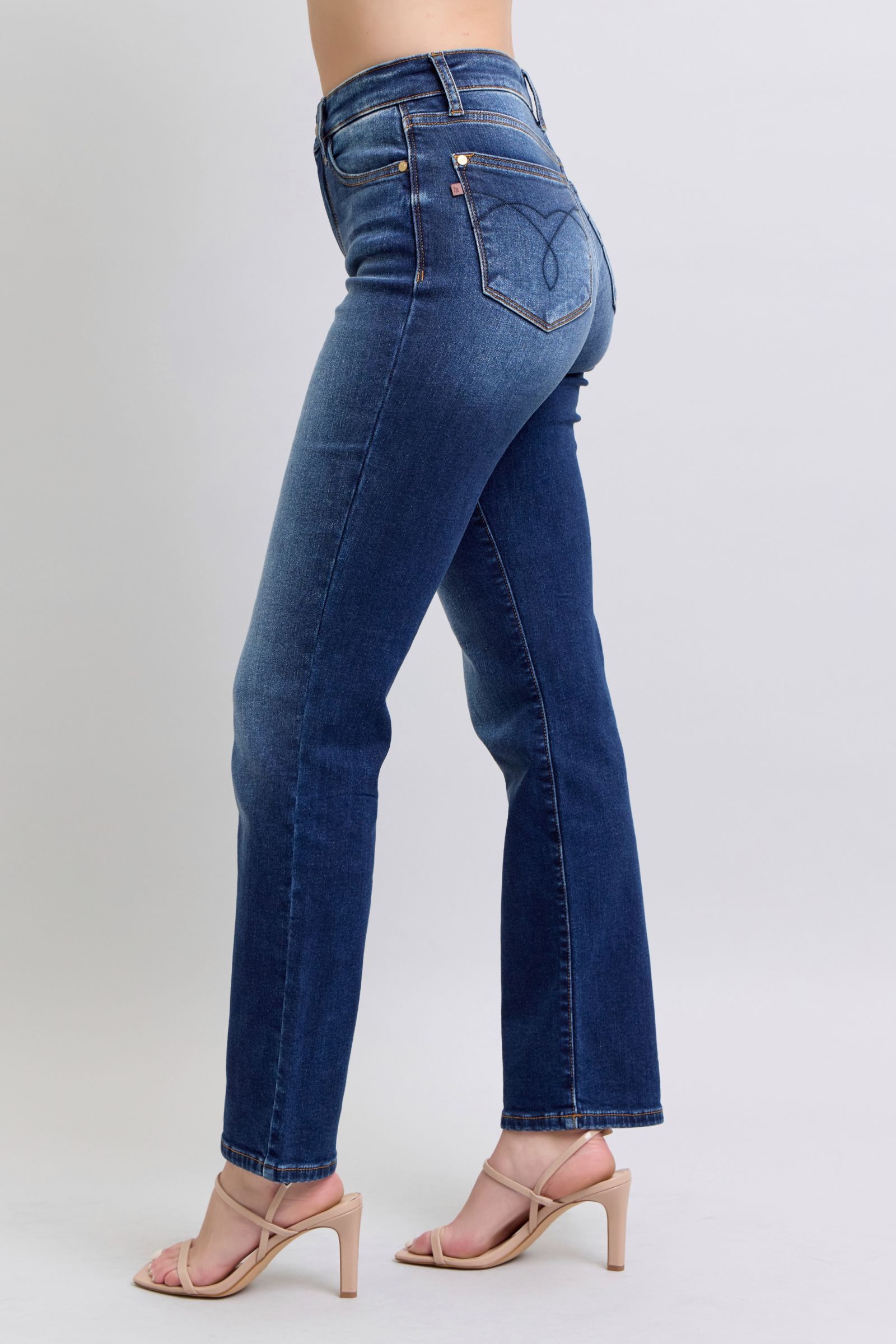 Pocket detail on Judy Blue washed straight-leg jeans showcasing practicality and style.
