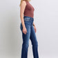 Styled look of Judy Blue straight-leg jeans paired with heels and a tucked-in blouse.
