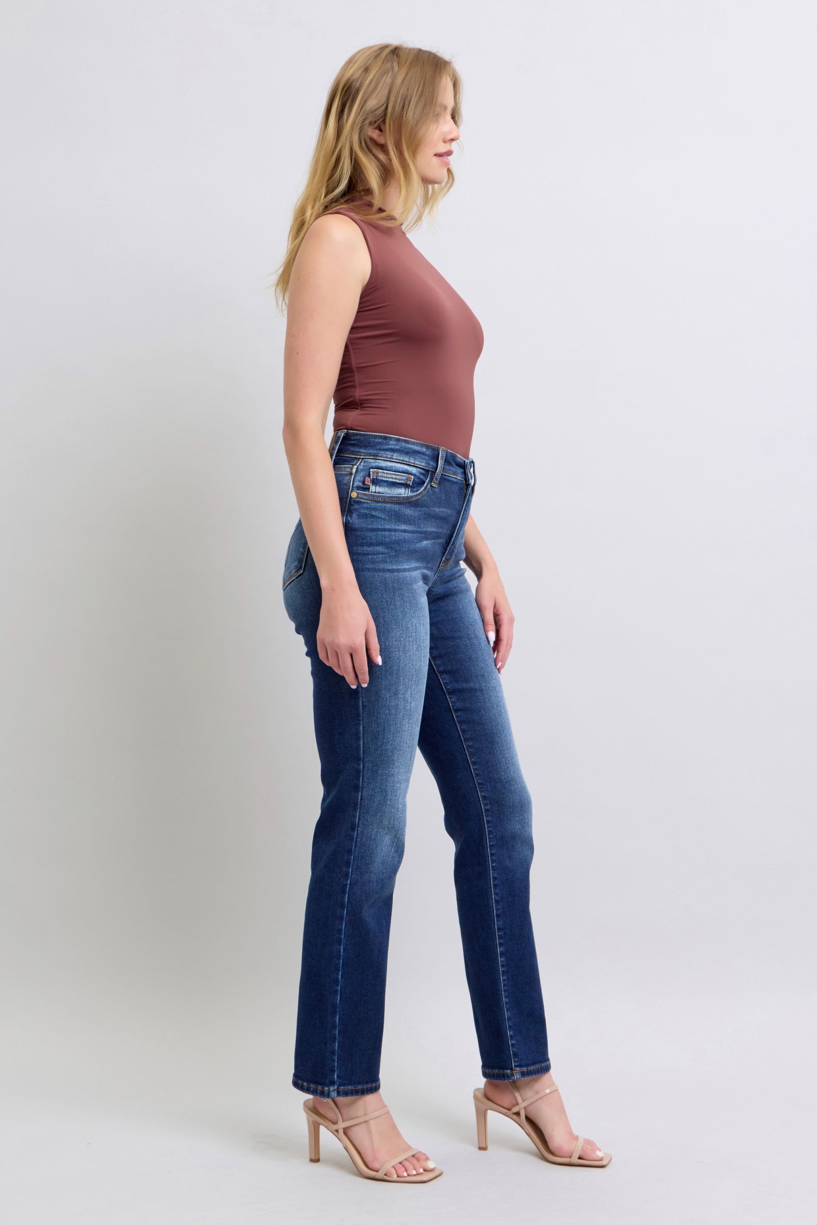 Styled look of Judy Blue straight-leg jeans paired with heels and a tucked-in blouse.
