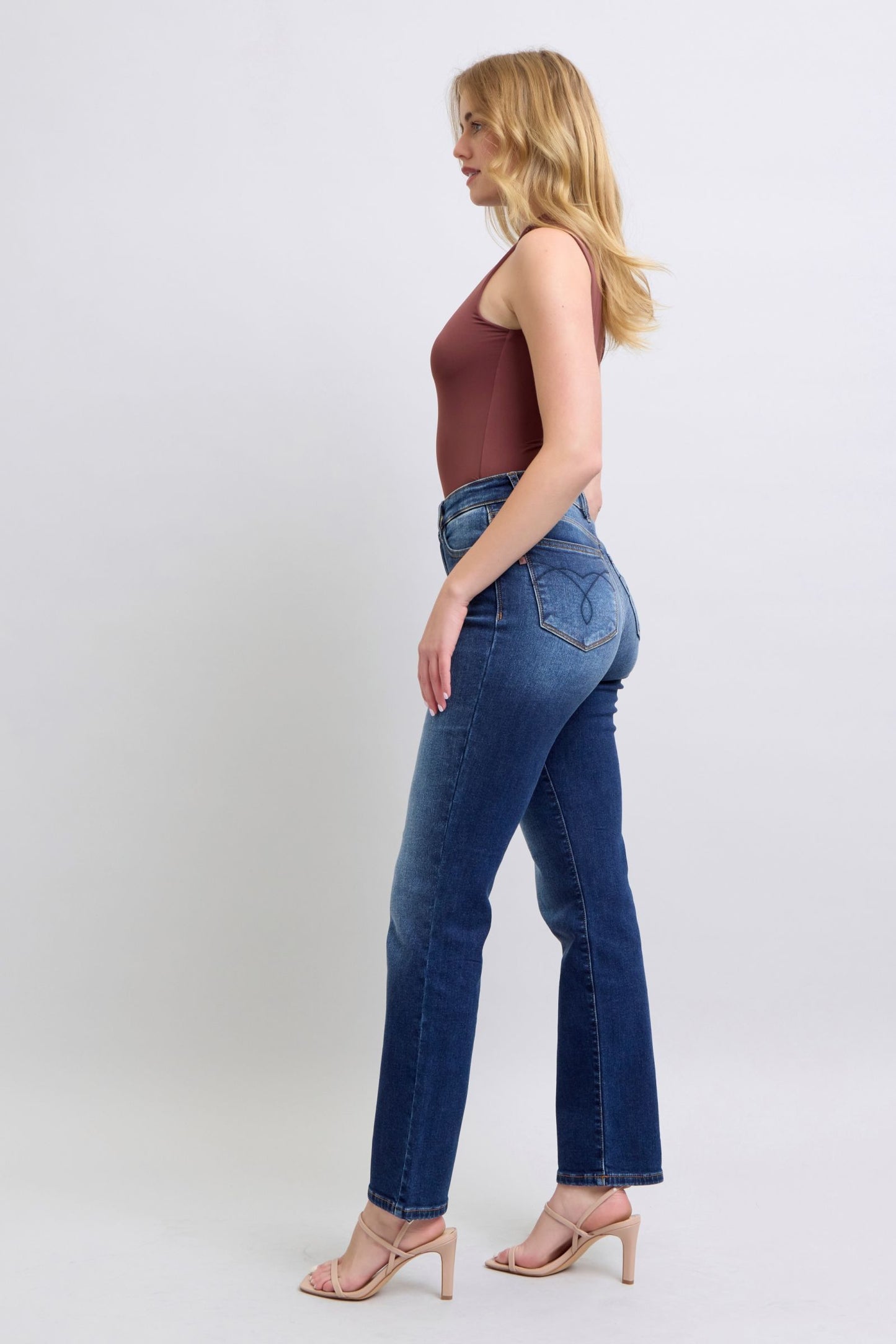 Waistband detail on dark wash Judy Blue straight-leg jeans with secure button closure.
