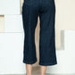 Wide-leg Judy Blue jeans styled with neutral heels for a chic look.
