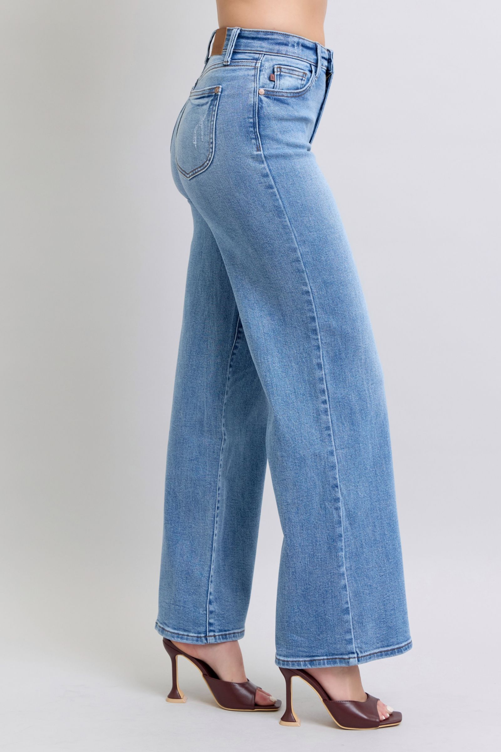 Side view of Judy Blue wide leg jeans in light wash highlighting pocket detail.
