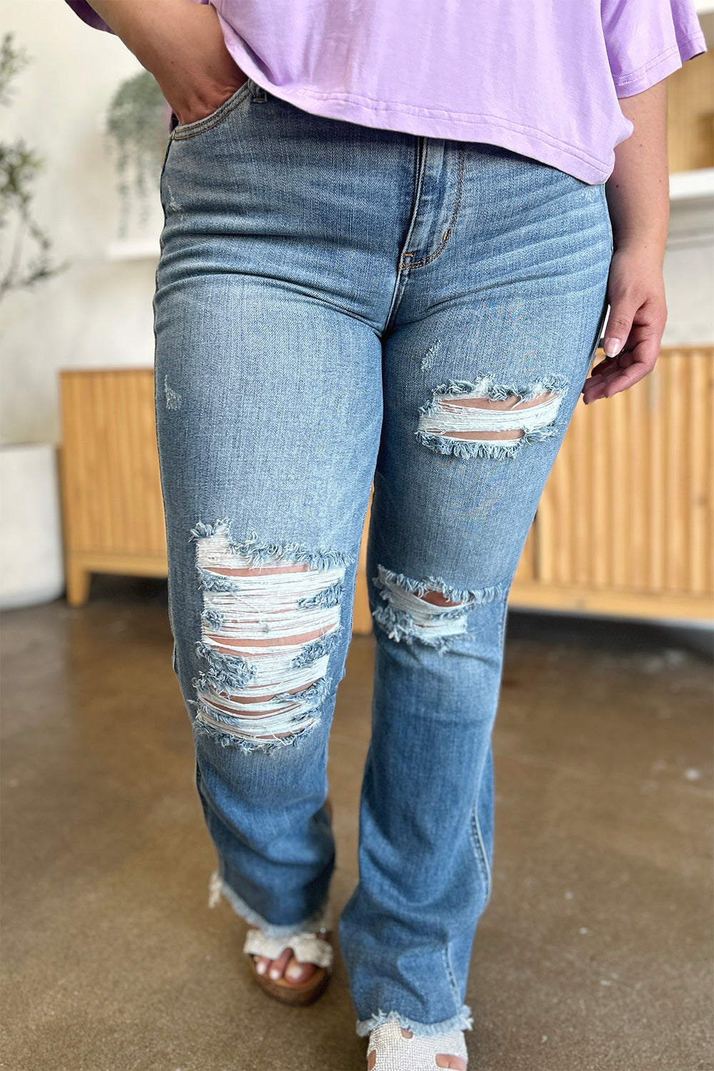 Front view of Judy Blue Distressed Raw Hem Bootcut Jeans showcasing distressed detailing and raw hem.