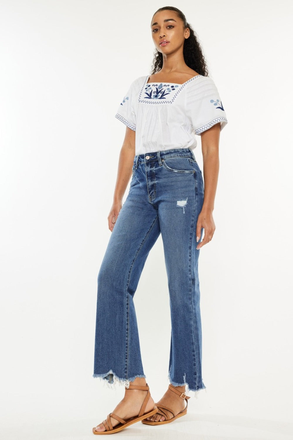 Kancan slim wide leg jeans in medium blue with a high waist and stylish raw hem.
