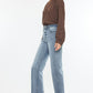 Back view of Kancan high-rise slim wide leg jeans in light wash with a raw hem.
