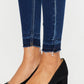 Ankle-length skinny jeans by Kancan with raw hem and slight distressing.
