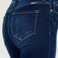 Kancan dark wash skinny jeans with high-rise waist and frayed hems.