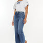 Women's high-rise Kancan jeans with a slim wide leg cut and distressed hem detail.
