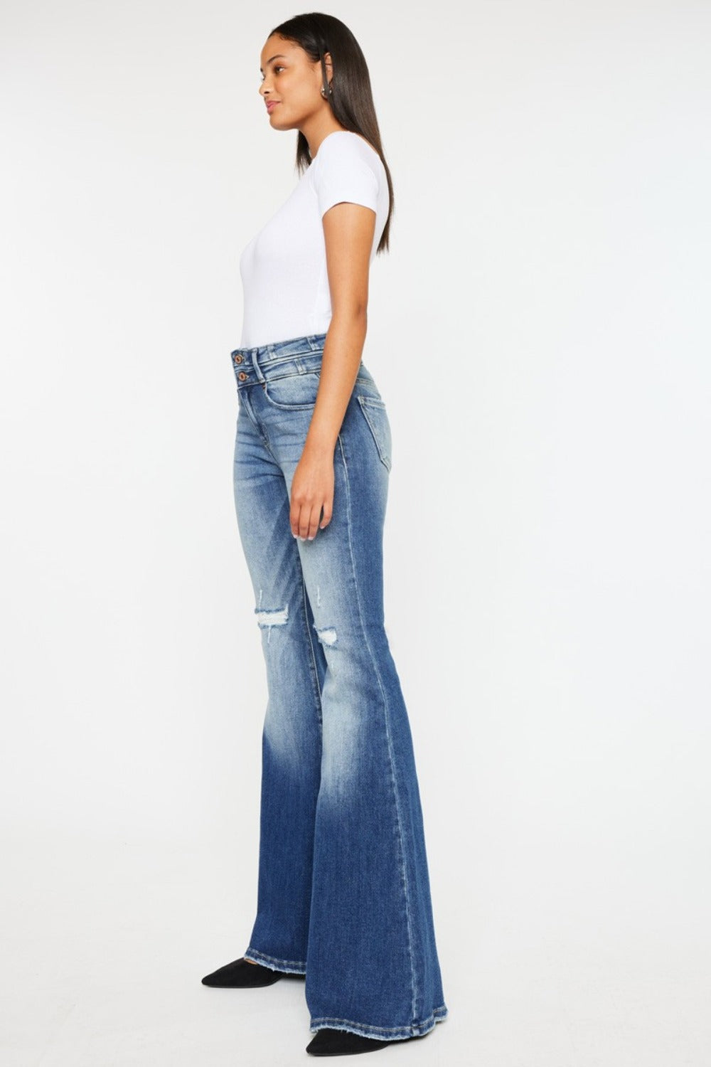 Women's wide waistband jeans with flared leg, distressed style, and medium wash.
