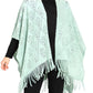 Front view of a mint green knitted fringe poncho, showcasing the open-knit design.