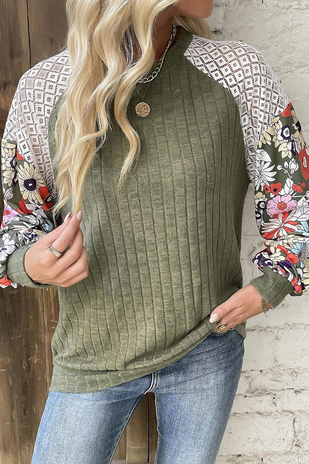 Relaxed fit olive top with floral and lace patchwork sleeves, styled with jeans