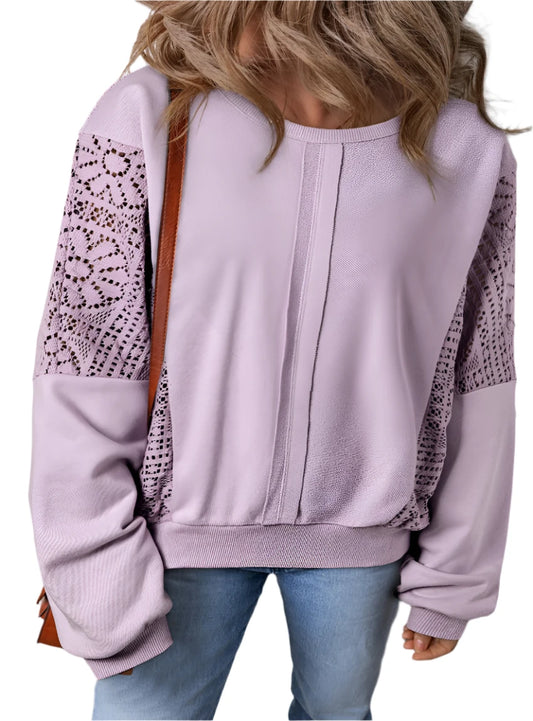 Woman wearing lace sleeve sweatshirt in soft pink
