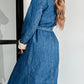 Back view of denim coat with lace-up detail and lambswool lining
