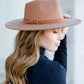 Latte wide brim Panama hat with a tassel belt shown from the side profile.
