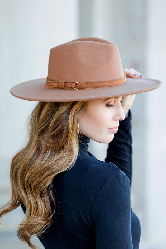 Latte wide brim Panama hat with a tassel belt shown from the side profile.
