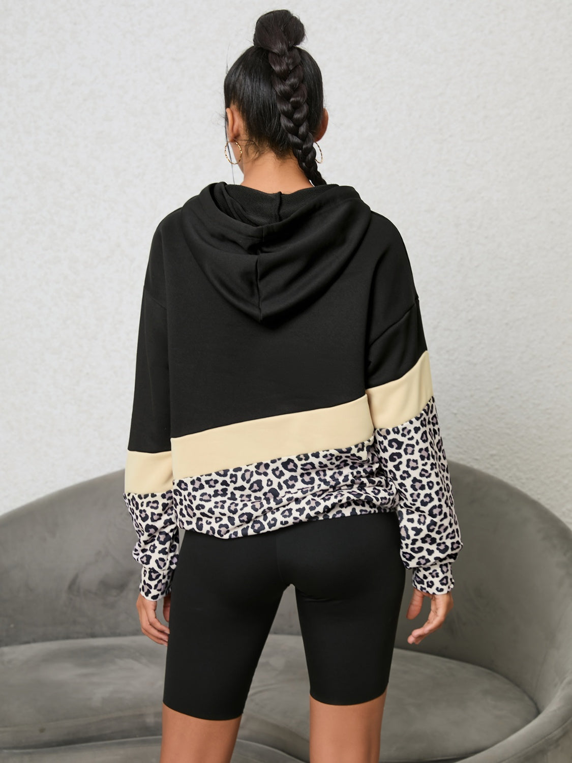 back view of cozy black hoodie with leopard print detail
