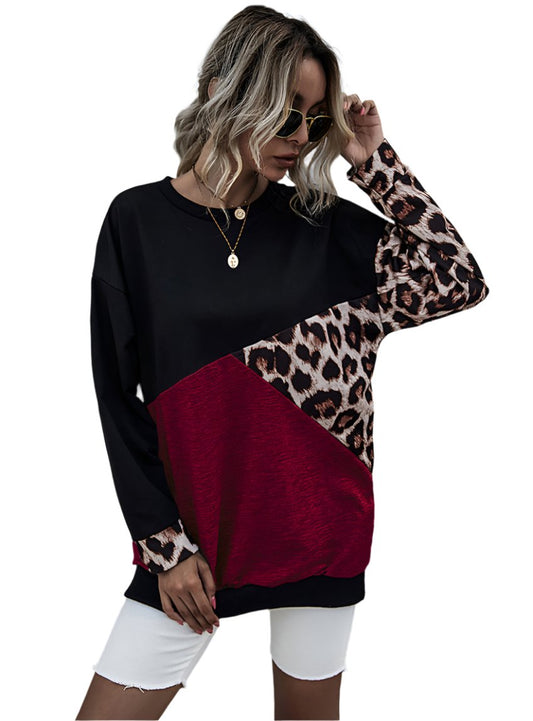 Woman wearing oversized leopard print sweatshirt with color-block design
