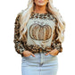 Front view of fun leopard print pumpkin long sleeve top, styled for fall with a denim skirt.
