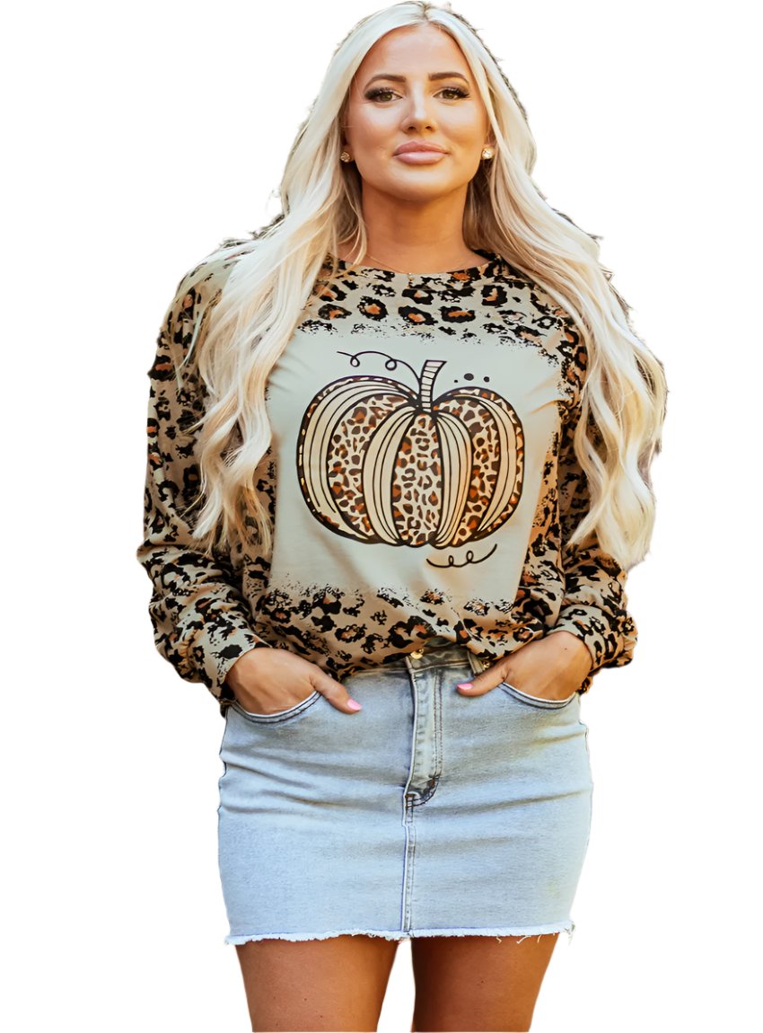 Front view of fun leopard print pumpkin long sleeve top, styled for fall with a denim skirt.
