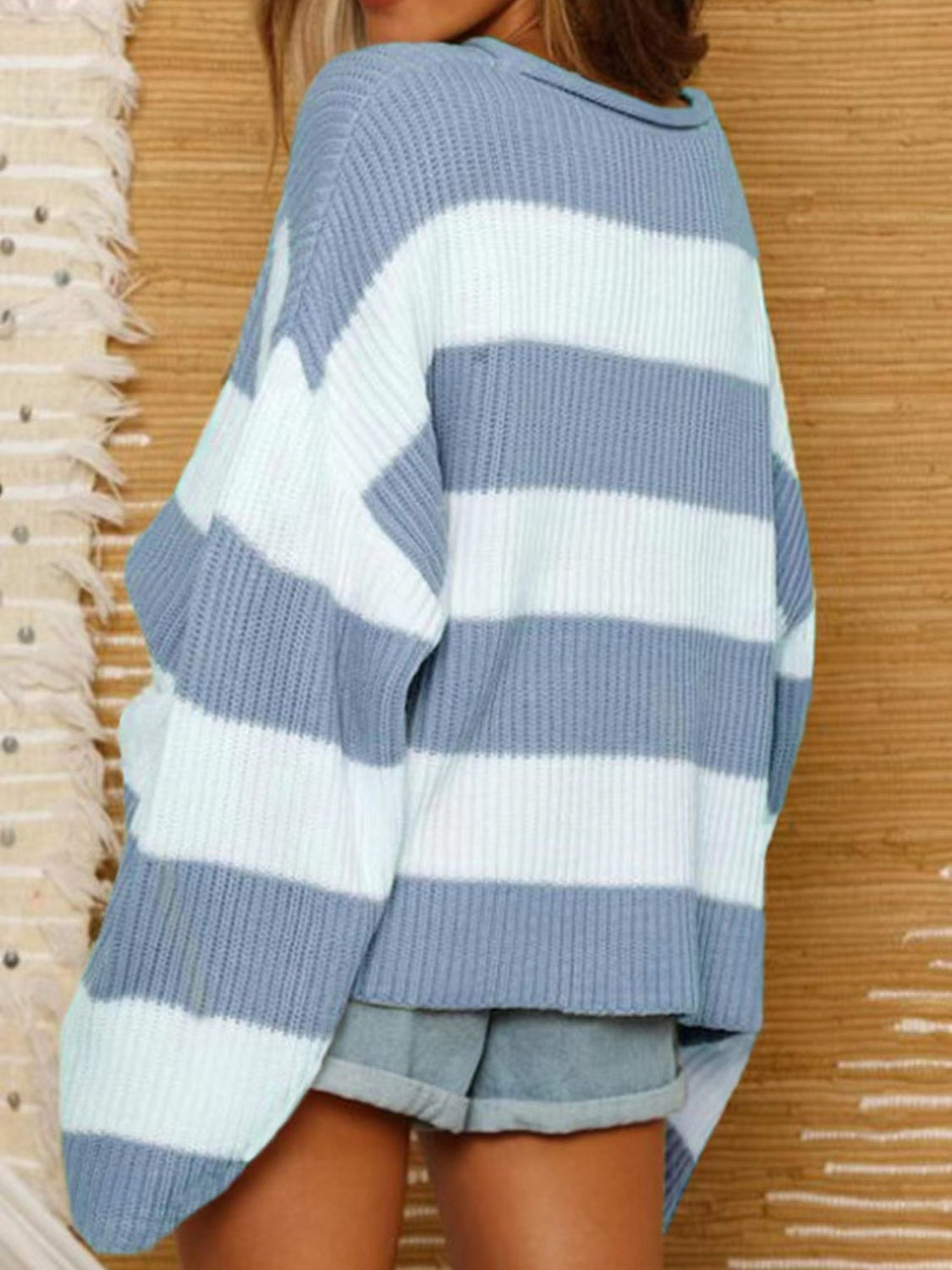 Light blue ribbed knit sweater with white stripes for a classic look.
