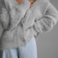 Light gray oversized button-front cardigan with a fuzzy texture
