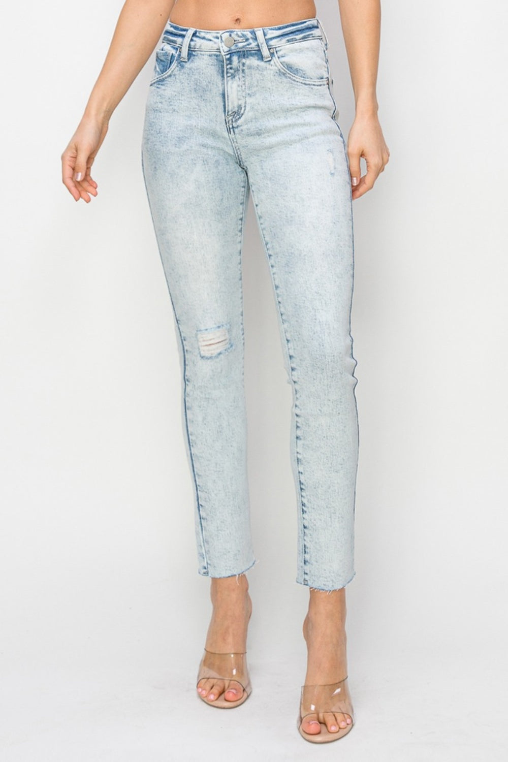 Women's high-rise skinny jeans with light distressing and frayed hem
