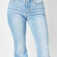 Flattering Judy Blue flare jeans with slit leg and raw hem in light wash, mid-rise fit.