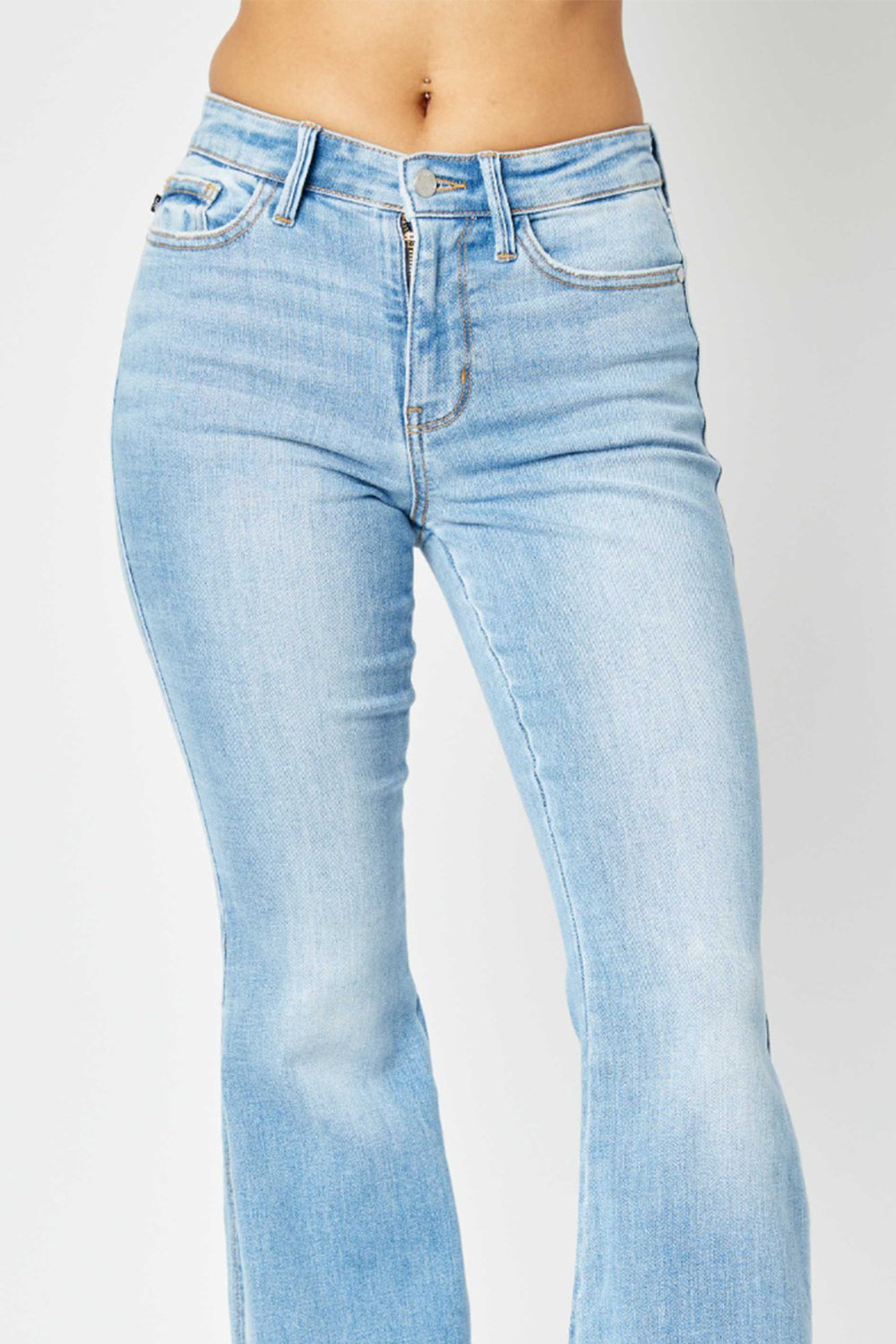 Flattering Judy Blue flare jeans with slit leg and raw hem in light wash, mid-rise fit.