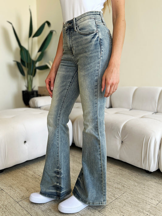 Detail of front pockets on mid-rise flare jeans.