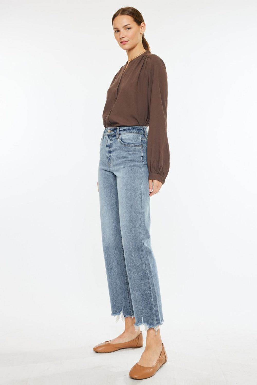 Kancan light wash jeans featuring a high-rise waist and raw hem for a laid-back look.
