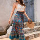 Side profile of a lightweight blue patchwork maxi skirt in an A-line silhouette.
