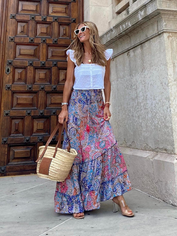 Lightweight blue tropical print maxi skirt with playful ruffles.
