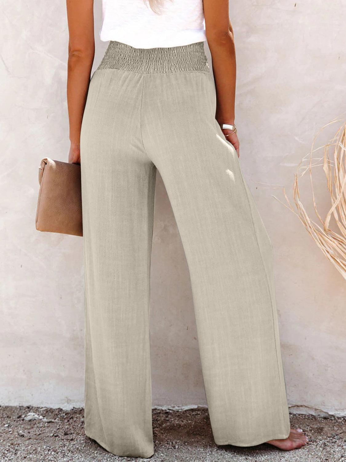 Lightweight khaki wide-leg pants with a high-waist and button accents.