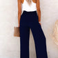 Stylish wide-leg pants for women in navy with button and smocked waist details.