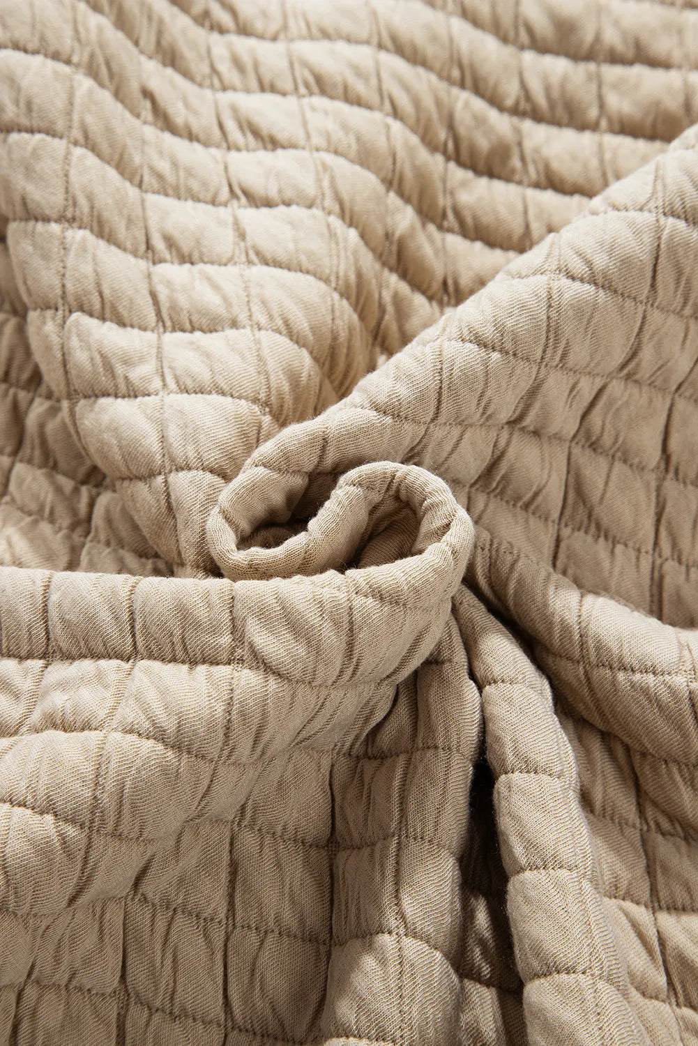 Lightweight quilted jacket in oatmeal with close-up details.
