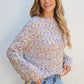 Casual confetti knit sweater with multicolored speckles and ribbed hem